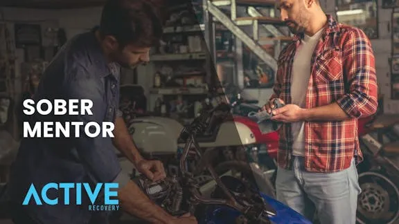sober mentor and client working in garage