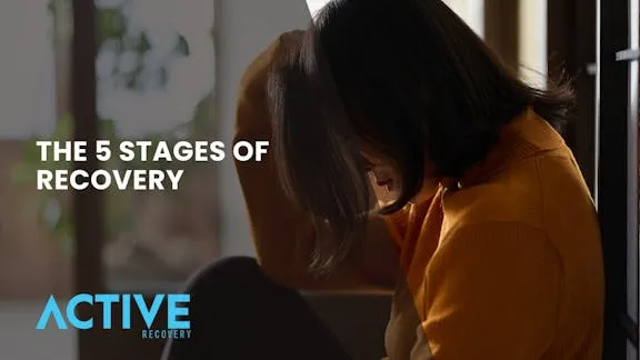 Depressed woman leaning on the wall during her 5 stages of recovery