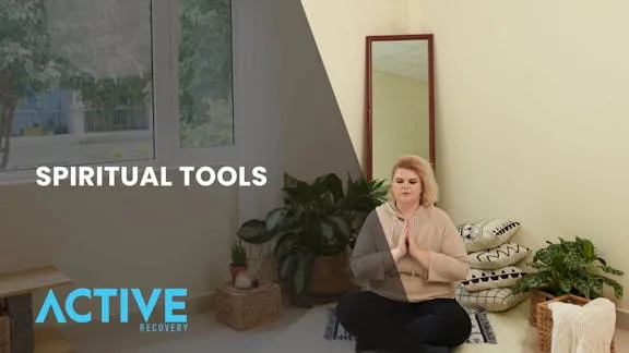 Woman meditating at home as part of her spiritual tools