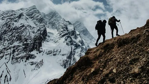 A sober coach and client climbing a mountain