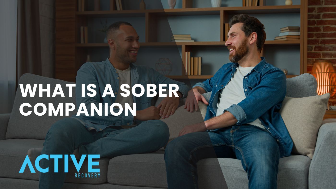 male sober companion with client sitting on couch